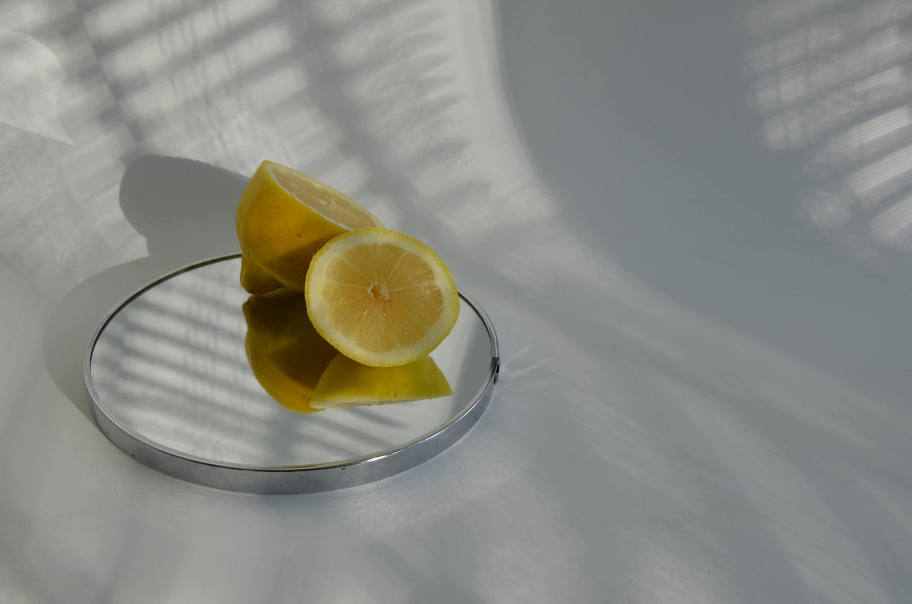 Bright yellow lemons arranged on a pastel green background, symbolizing the fresh approach to clitoral pleasure with lemon vibrators