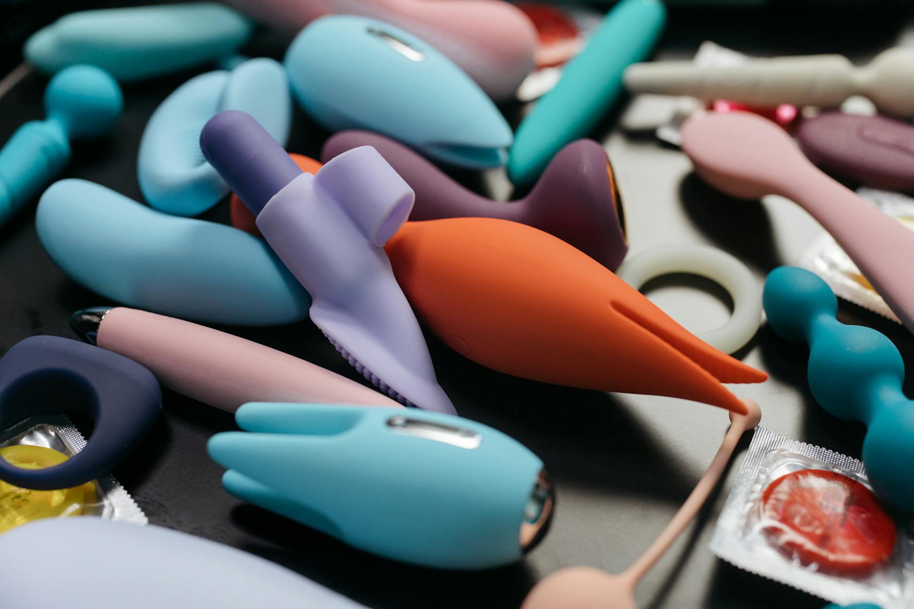 A person holding a basket of colorful vibrators, representing diverse pleasure options for mature bodies.