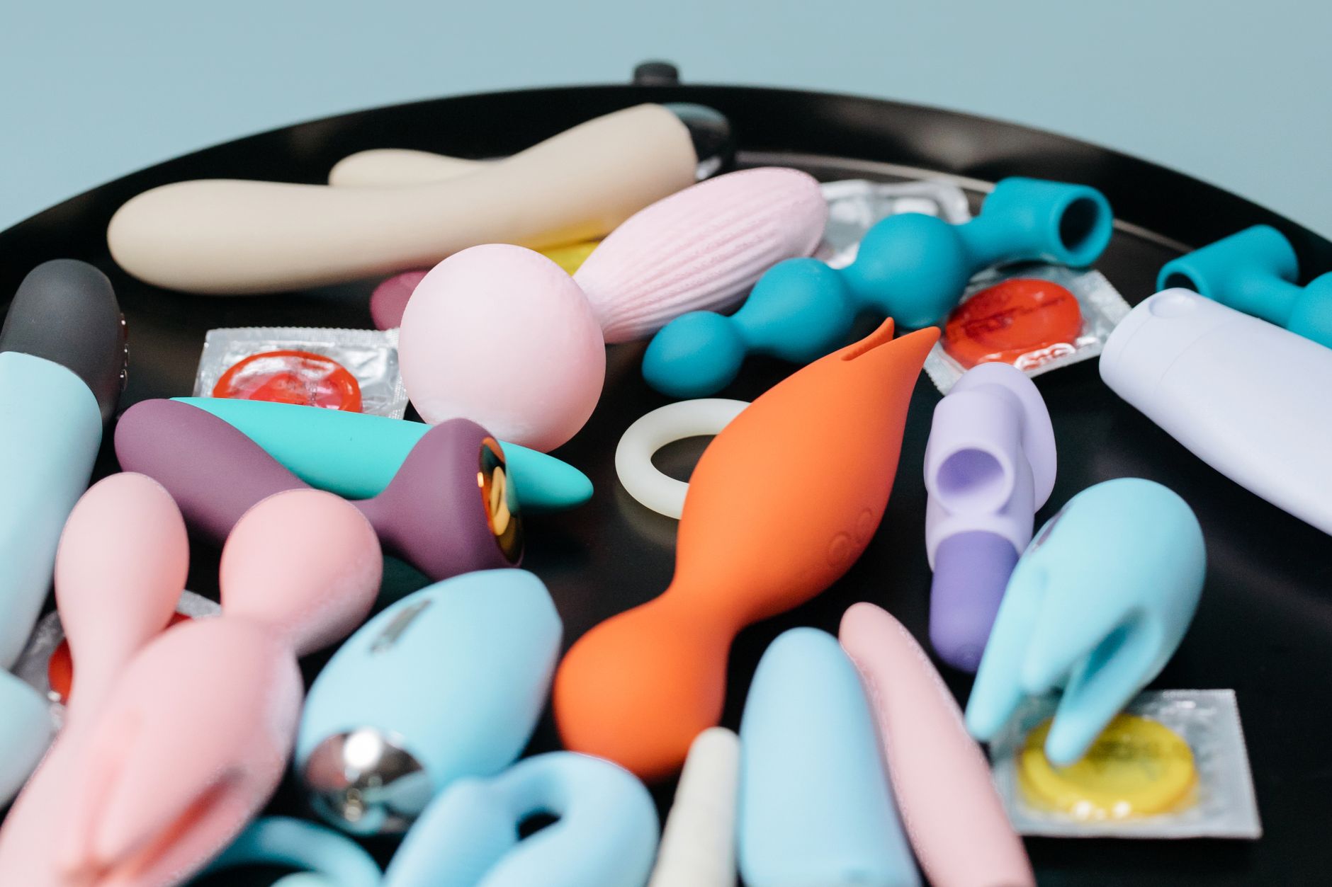 Hand holding a vibrator against a minimalist backdrop, representing sensual recovery